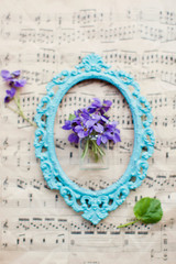 Violets flowers and vintage blue frame