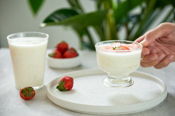 Healthy breakfast greek yogurt and fresh berries in hands of man. Health food from yogurt concept Selective focus