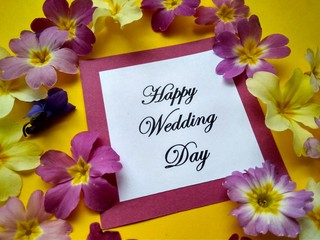 The inscription Happy Wedding Day with flowers on a colored background