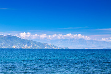 Wonderful romantic summertime seascape with crystal clear azure sea and coastline slopes.