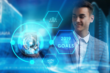 The concept of business, technology, the Internet and the network. A young entrepreneur working on a virtual screen of the future and sees the inscription: 2019 goals