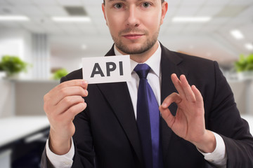 Business, technology, internet and networking concept. Young entrepreneur showing keyword: API