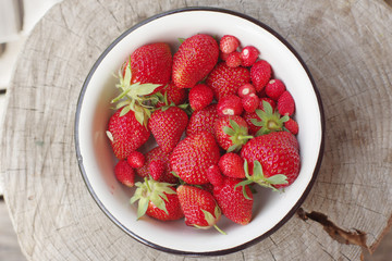 strawberries in a bowl on wooden table