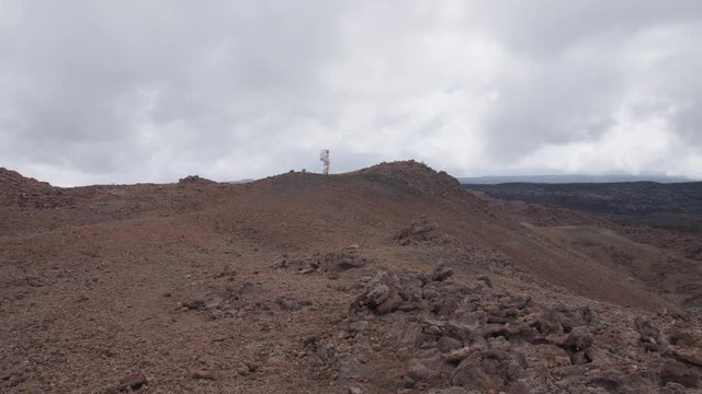 Astronaut standing on a  hilltop in a Martian landscape, Hawaii