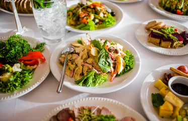 Buffet table of reception with cold snacks, meat and salads