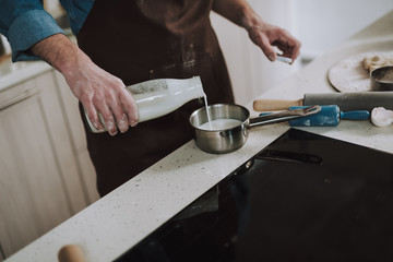 Close up of the milk pouring process in the kitchen