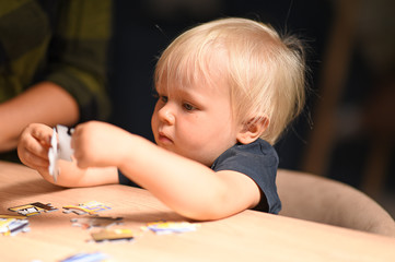 blond child playing with a puzzle