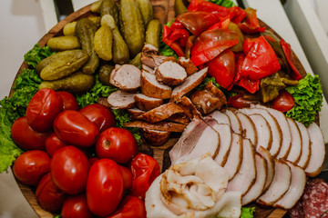 Delicious snacks with bacon, tomatoes, cucumbers and bread