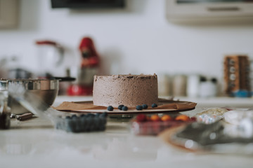Beautiful cream cake with several blueberries near it