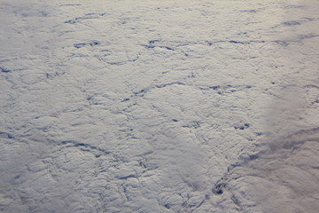 Photos of clouds from a height. Cloudy sky. Beautiful clouds in the blue sky. Clouds in clear weather. Sky texture The texture of the clouds. The texture of the earth. View of the ground from a height