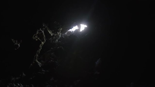 Astronaut getting in a Martian cave, Mauna Loa Volcano, Hawaii