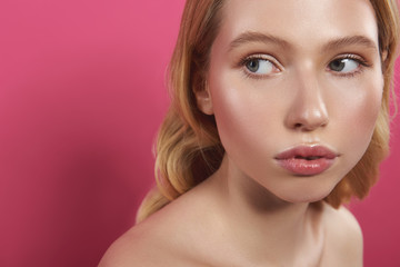 Fototapeta premium Pretty sensual fair haired woman isolated on pink
