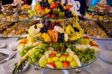 Beautiful fruity bright assorted sliced fruit on a rich festive table