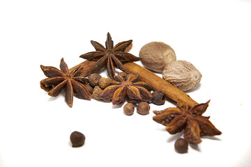 Fototapeta na wymiar Closeup spices cinnamon, anise, nutmeg white background.