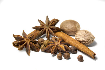 Closeup spices cinnamon, anise, nutmeg, allspice  white background.