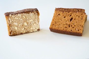 close up  slices of traditional Dutch spiced caked called ontbijtkoek or peperkoek, with butter.. Against white background. Space for text