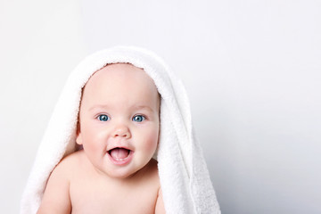 Baby child portrait in towel empty space background.