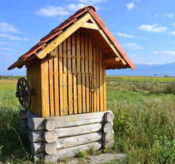 Wooden water well on the meadow, Romania