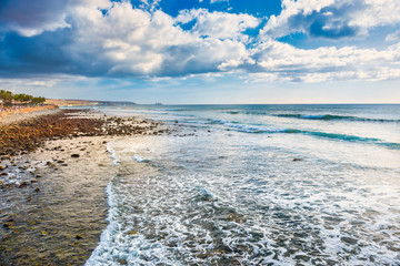 Stone coast and beach of Atlantic ocean at Maspalomas. Gran Canaria island, Spain