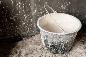 Construction bucket with lime. © Natallia