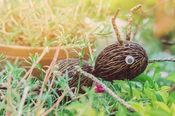 An artificial ant statue made from coconut, decorated on trees in the garden.