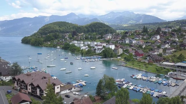 Boat dock at the small Swiss town of Thun. Magnificent view of lake Thun and the Alps.