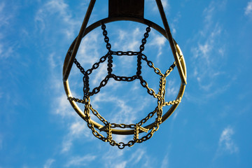 Detail of basketball basket outdoors in blue sky