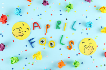 All fools day background concept with holiday accessories, April 1st themed party attributes. Close up, copy space, top view, flat lay.