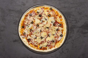 Ready to oven step. recipe step by step pizza capricciosa flatlay on grey stone