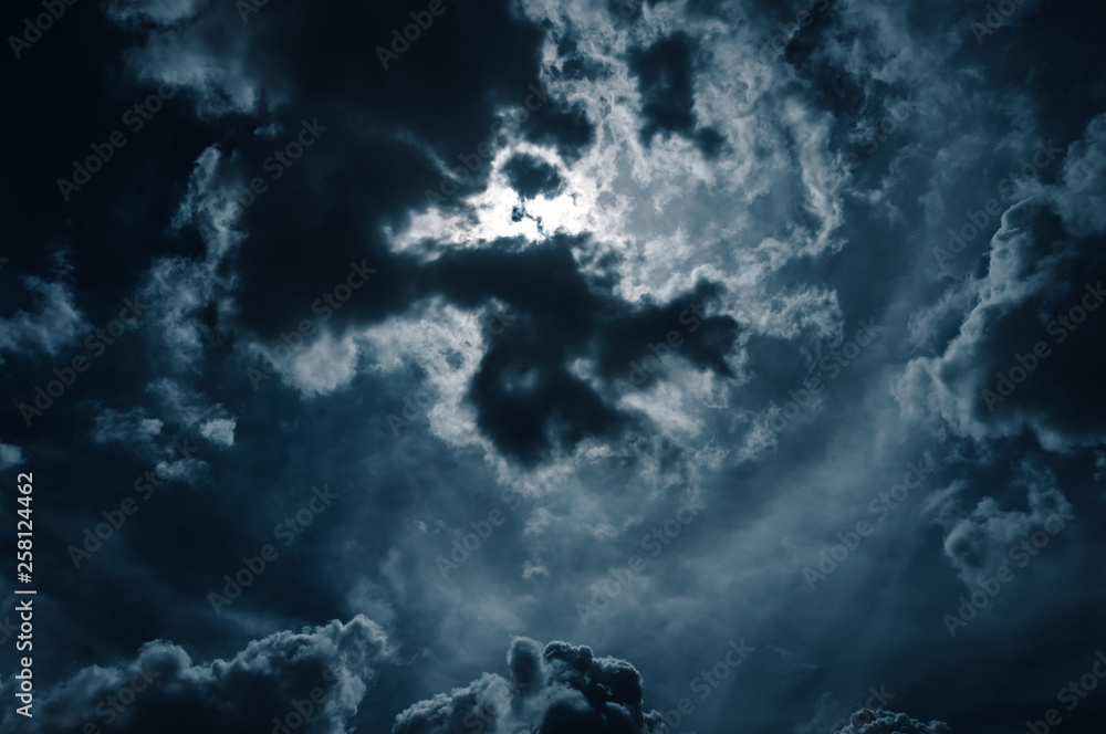 Wall mural moonlight shines behind a cloudy at night. serenity nature background.