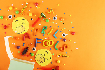 All fools day background concept with holiday accessories, April 1st themed party attributes. Close up, copy space, top view, flat lay.