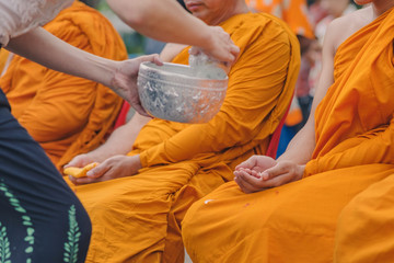 People pouring water to Buddhist Monk and gives blessing in Thailand Songkran annual festival in Buddhist temple.