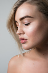 Closeup portrait of a young girl with long eyelashes and nude makeup