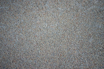 Concrete texture. Horizontal background of gray concrete floor with many small stones.