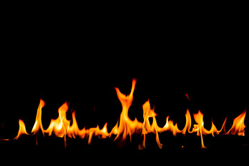 Fire flames on Abstract art black background, Burning red hot sparks rise, Fiery orange glowing flying particles