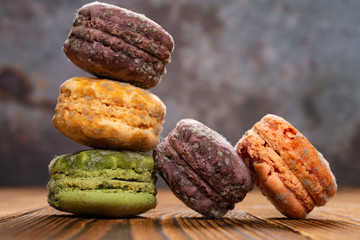 5 pcs moldy macaroons on a wood table close up