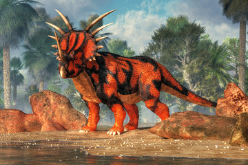 A red and black sytracosaurus stands on the sandy shores of a cretaceous era lake.  This spiky dinosaur is posing just for you. 3D Rendering