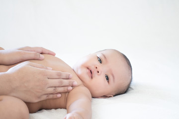Mother hands touching baby with love and care, Asian baby girl after shower on the white background