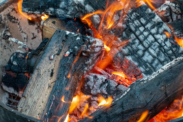 Glowing fire on cracked logs in a fire pit outdoors ~FIRESIDE~