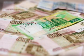Obraz premium money background, Russian hundred-ruble and two-ruble bills in a mess lying on the table.