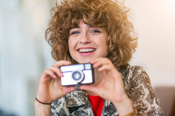 Woman taking photo with vintage camera