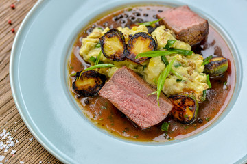 grilled beef steak with vegetables and tomato sauce