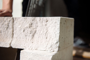 young man sawing a foam block with a saw