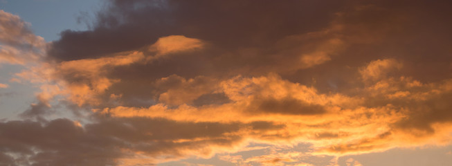 Dark orange clouds during the sunset. Panorama_