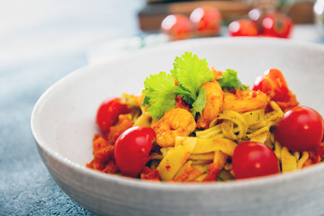 Cooked pasta with peeled shrimp, coconut milk sauce and broccoli