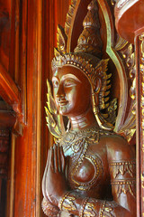 old wooden statue in a buddhistic temple