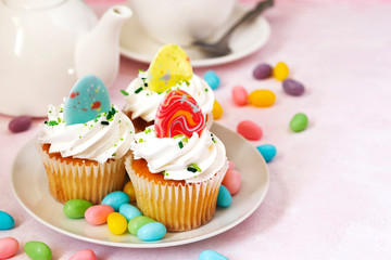 Easter vanilla cupcakes on pink background, copy space