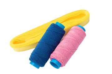 two spool of thread and ribbon.on a white background isolated
