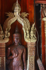 Fototapeta premium old wooden statue in a buddhistic temple