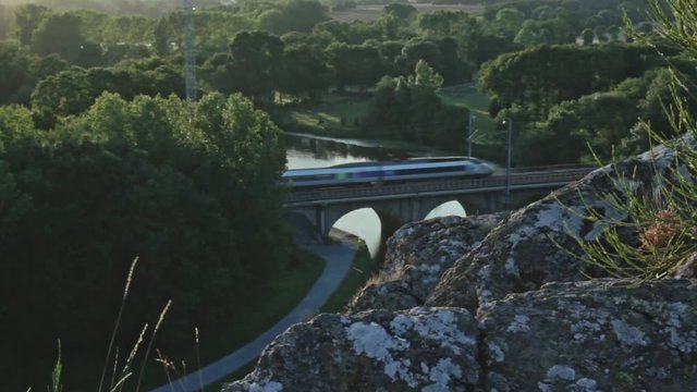 High Speed Train passing on A Bridge in a Valley